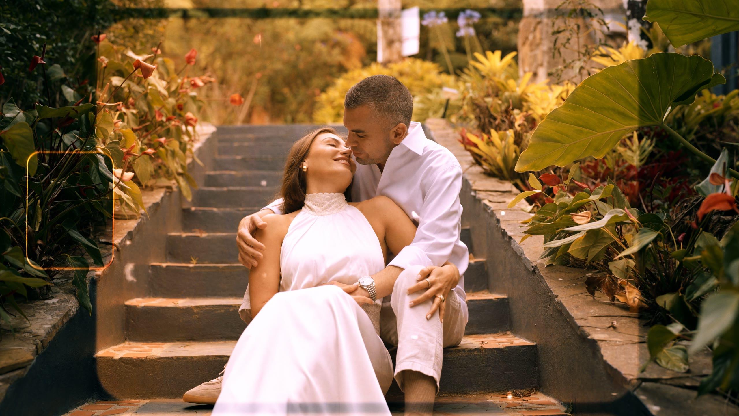 Valeria and René seated together on garden steps